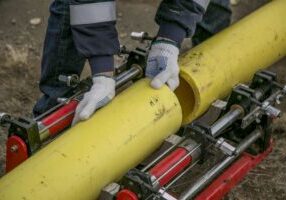 A Person Holding Yellow Pipes