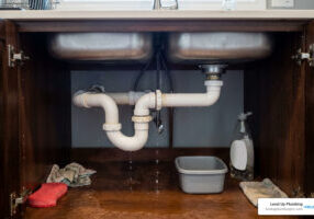 leaking pipe joint under a kitchen sink